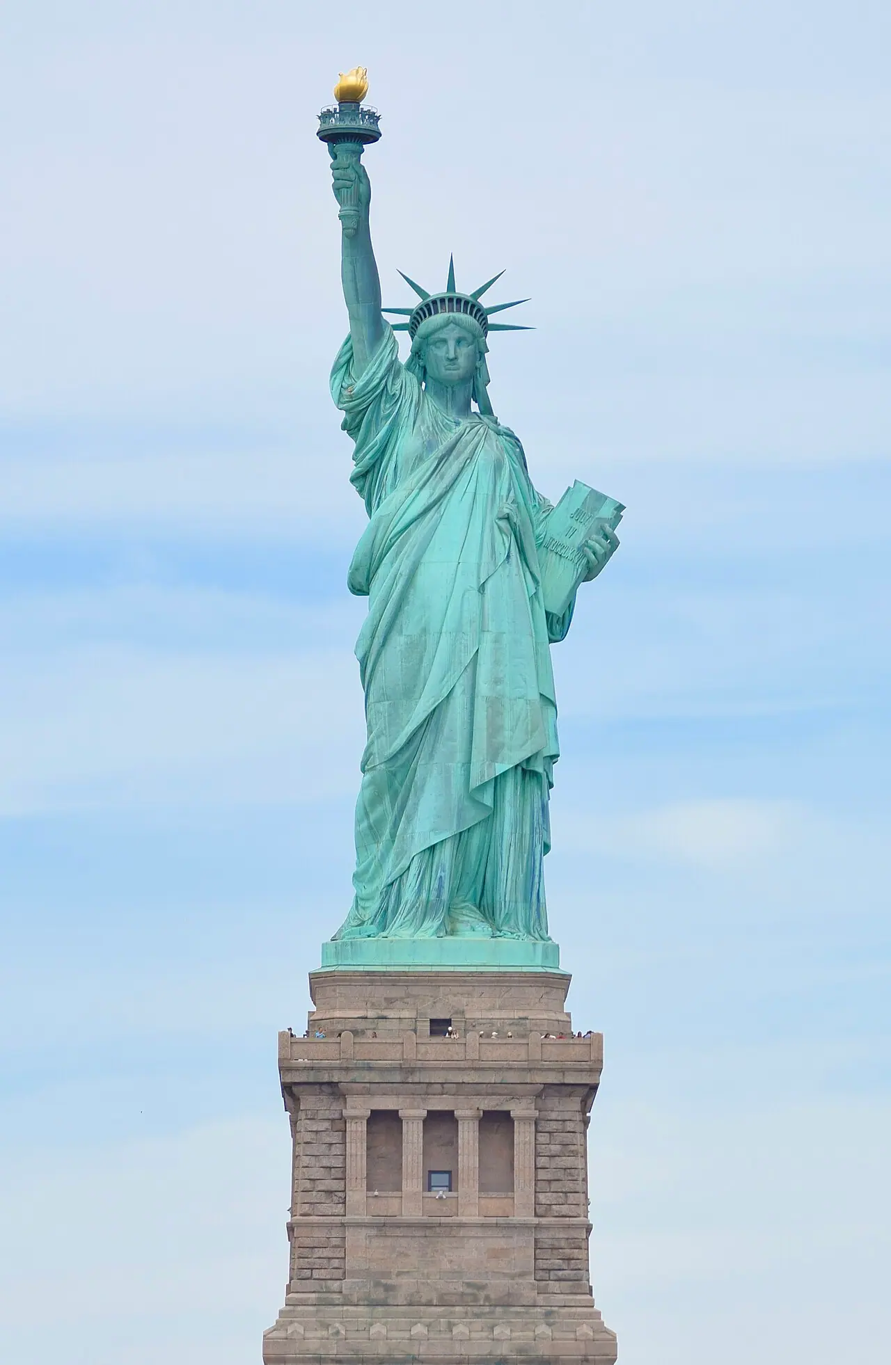Front view of the Statue of Liberty, New York Harbor (Wikimedia Commons photograph by Elcobbola, public domain)—symbolic U.S. immigration context for policy reporting; not an ICE facility, courtroom exhibit, or identifiable detained family.