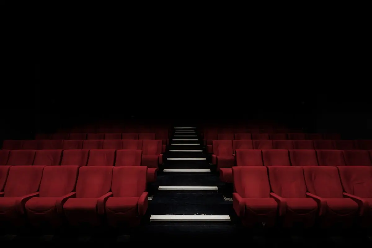 Empty cinema-style seating and stage glow suggesting live television spectacle—not the official Eurovision stage design or logo.