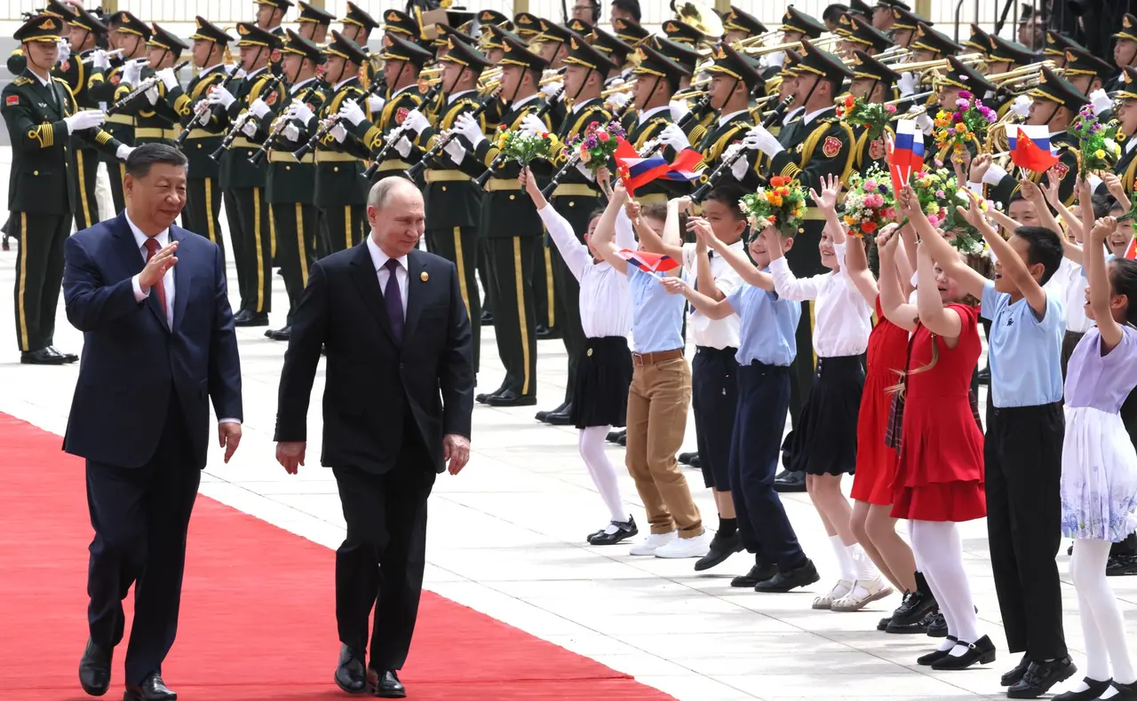 Xi Jinping and Vladimir Putin at a 2024 welcome ceremony in Beijing—archival Kremlin-released photograph illustrating the leaders’ summit habit, not the May 2026 visit itself.
