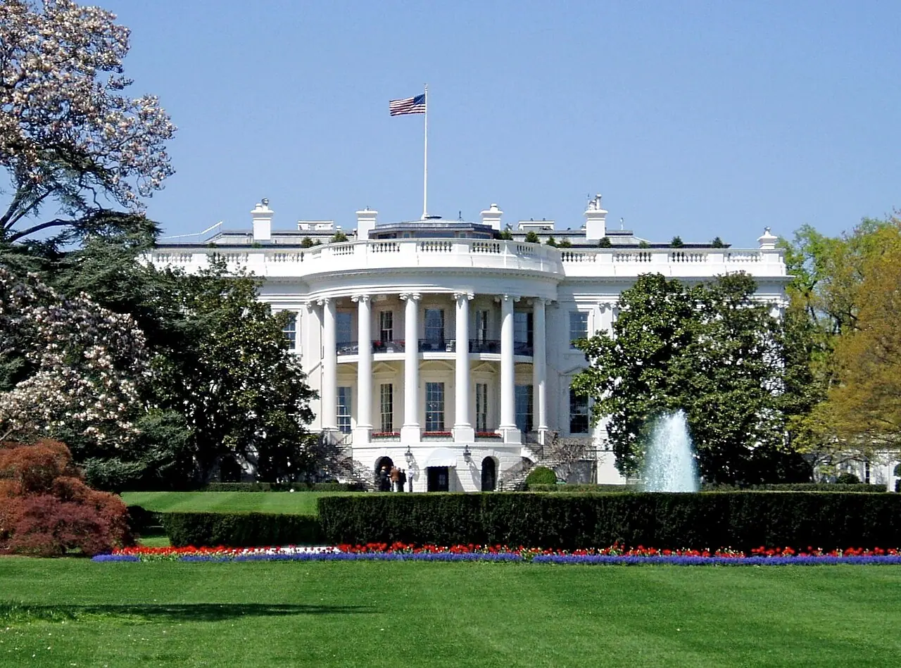 South façade of the White House executive mansion, Washington, D.C., May 2006 (Wikimedia Commons photograph by Matt H. Wade, CC BY-SA 3.0)—the complex where East Wing ballroom and state-room funding fights play out in budget politics; not a live House or Senate vote tally, CBO spreadsheet, or construction site photo from this story.